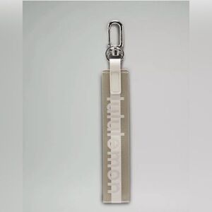 Lululemon Never Lost Keychain Wordmark Raw Linen/White/White Opal